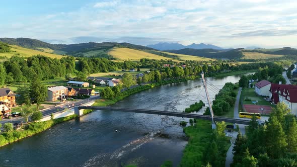 Aerial view of the bridge and the High Tatras in the village of Cerveny Klastor in Slovakia