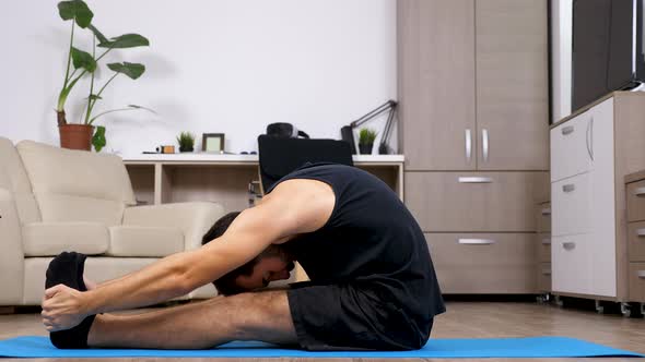 Man Stretches and Does Different Yoga Poses