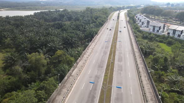 Aerial view of Highway and Oil Palm Plantation in Desa Pinggiran Putra