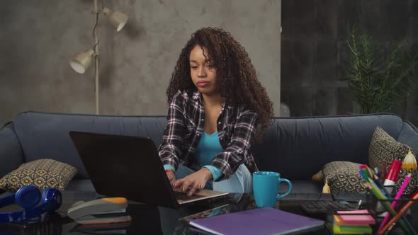 Exhausted Female Freelancer Finishing Work Indoors