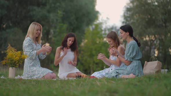 A Group of Young Girls in the Open Air Conduct a Master Class in Clay Modeling