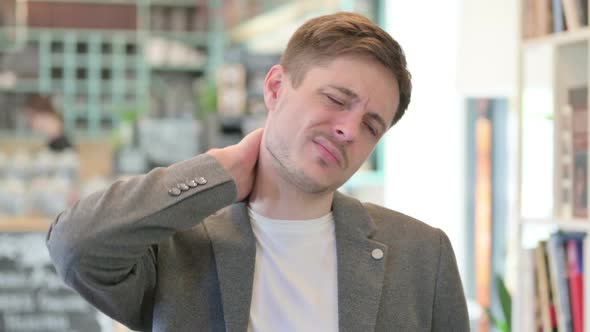 Portrait of Young Man Having Neck Pain