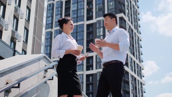 Business People Stand on the Stairs and Talk About Project Financial Report