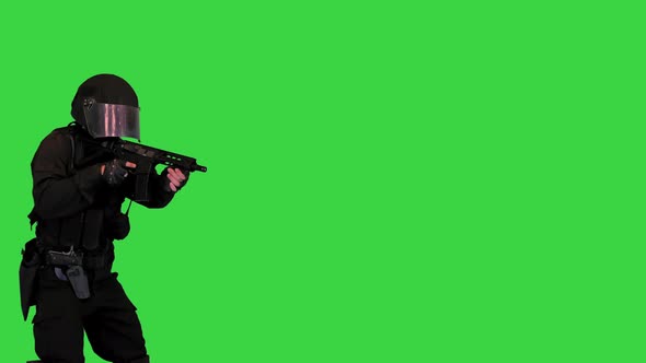 Anti Terrorist Unit Policeman Walking and Aiming with a Rifle on a Green Screen Chroma Key