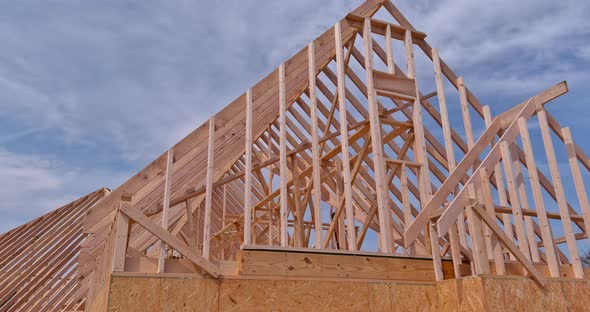 Framing Beams of New Home Under Construction Wooden Roof Trusses