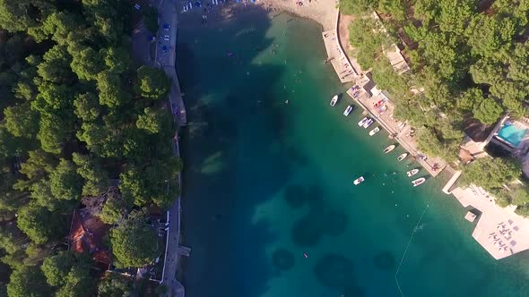 Aerial view of hidden beach surrounding by native forest, Croatia.