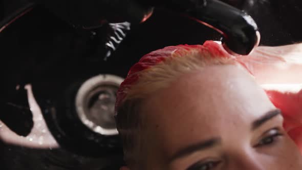 Close up view woman getting her hair washed