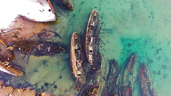Old sunken ships near coast in winter