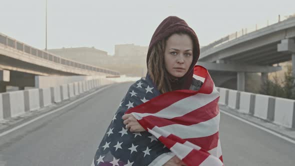 Cheerful Woman with USA Flag Posing on Highway