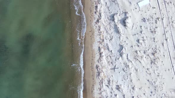 Buttery soft aerial view flight bird's eye view drone footage of the coastline and waves atnatural