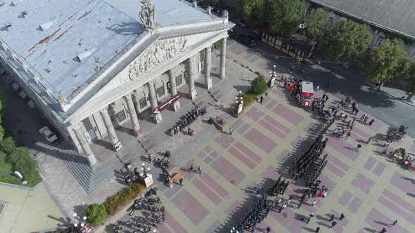 Aerial view of a military parade in front of the Theatre 