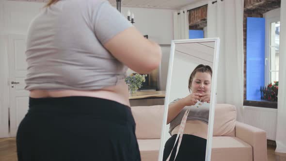 Fat Woman Examining Her Body in Mirror, Thinking of Becoming Slim