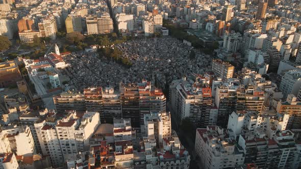 Aerial high angle shot flying towards La Recoleta Cemetery in Buenos Aires at golden hour