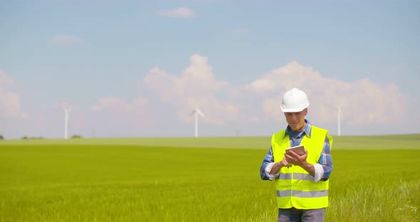 Male Engineer Working While Holding Blueprint