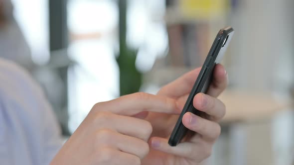 Close Up of Young Man Using Smartphone