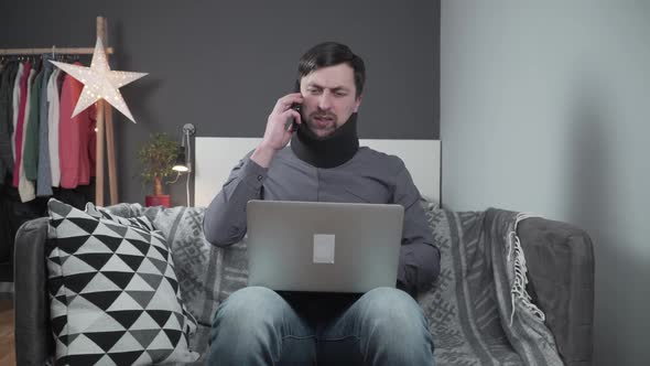 Man in Neck Brace Cervical Collar Working From Home Teleworking