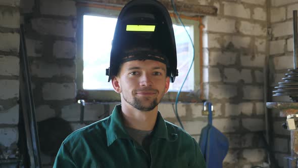 Welder Smiling and Looking at Camera