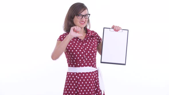 Stressed Woman with Eyeglasses Showing Clipboard and Giving Thumbs Down