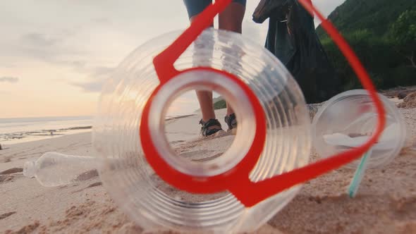 Young Caucasian Woman Eco Activist Collects Plastic Debris with Ocean Beach