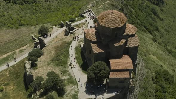 Tourists Visiting The Medieval Church Of Jvari Monastery On Mountaintop Near Mtskheta, Eastern Georg