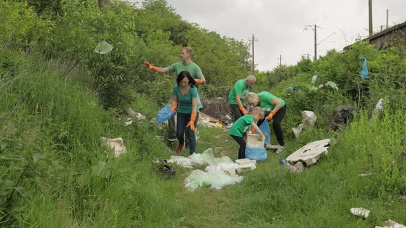 Volunteer Team Cleaning Up Dirty Park From Plastic Bags, Bottles. Reduce Trash Cellophane Pollution