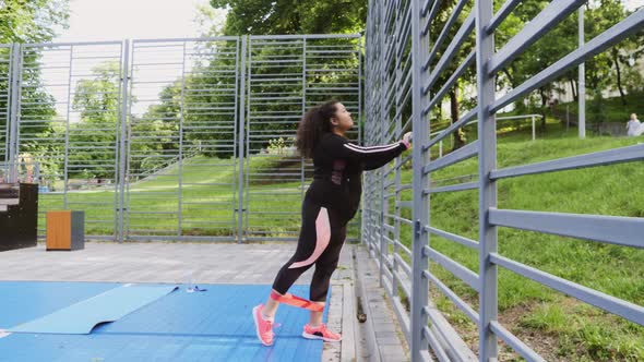 Over the Size of a Woman Doing Stretching Exercises