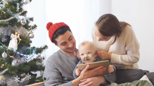 Happy Young Family at Home in Christmas