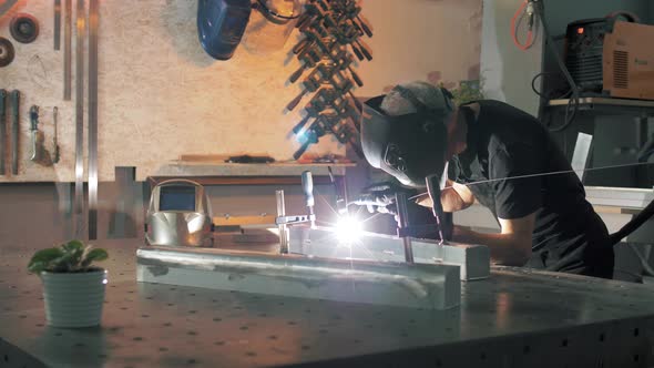 Master welder with experience welds aluminum construction with arc welding and argon