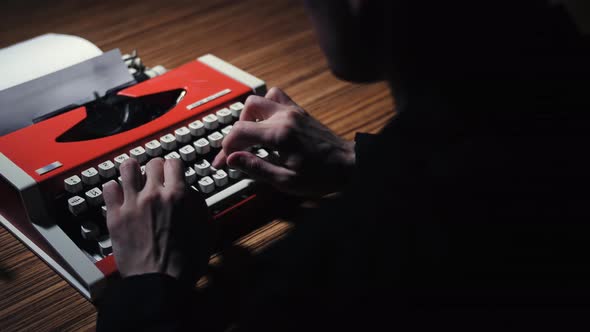 The Mysterious Silhouette of a Man Types Text on a Typewriter