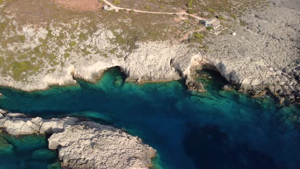 Aerial footage of stunning coastline with transparent waters in island of Greece.