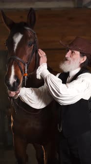 A Closeup of Senior Couple Petting a Horse in a Stable