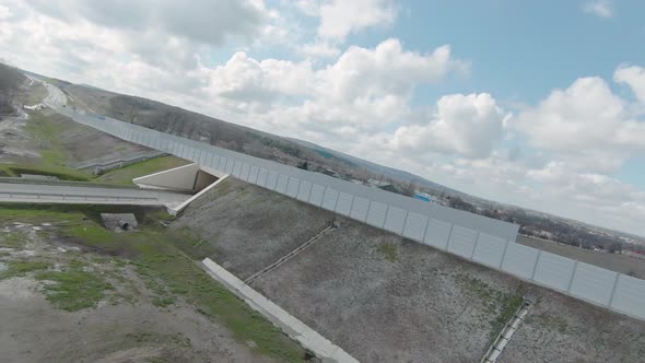 Flying drone on country road with tunnel