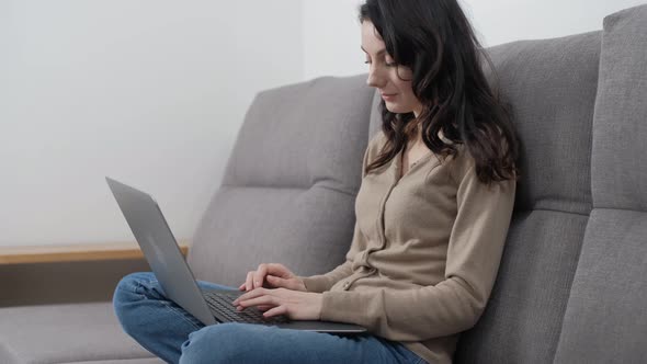 Woman working from home on lockdown. Freelance writer typing text on notebook at home