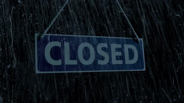 Passing Store Closed Sign In The Rain
