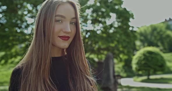 Attractive Smiling Woman Outdoors in a Park