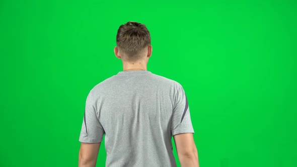 Back View of Man Walking and Greeting on a Green Screen, Chroma Key