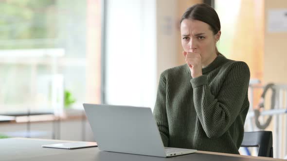 Young Woman with Laptop Coughing 