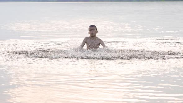 Boy is Bathed in the River and Splashing Water