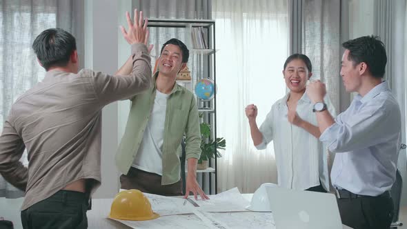 Group Of Asian Engineers Celebrating Finish Working At The Office