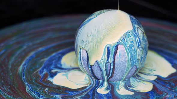 Paint Flows Down the Surface of the Texture Ball and Spreads Over the Table