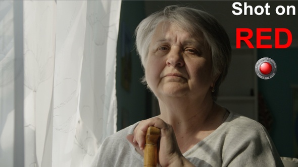 Portrait Of Sad Elderly Woman Looking At The Window Indoors Concept Of Depression Loneliness