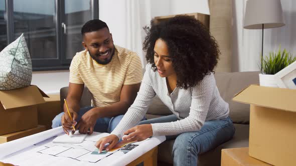 Couple with Blueprint and Color Palettes at Home