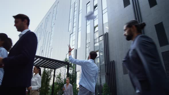 Upset Manager Throwing Papers Outside Office Building