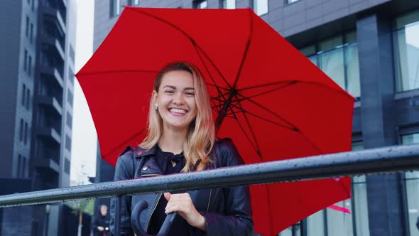 Happy Girl with Umbrella Laughing at Somebody