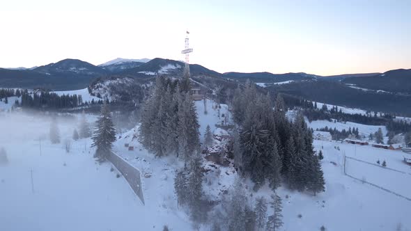 Aerial view of a cross on a cliff at Piatra Fantanele