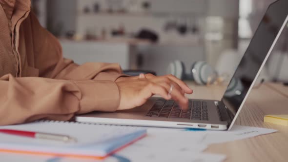 Hands Freelancer Woman Typing Article on Laptop Keyboard at Table with Papers