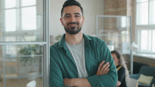 Portrait of Cheerful Middle Eastern Businessman in Office