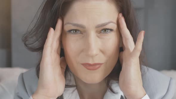 Close-up Portrait of Mid-adult Caucasian Woman Having Severe Headache. Sad Tired Stressed Lady with