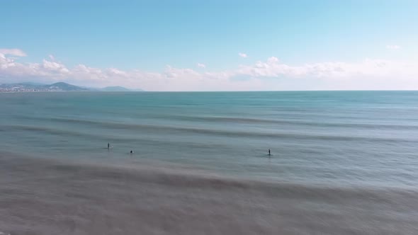 Surfers sitting on boards in beautiful sea