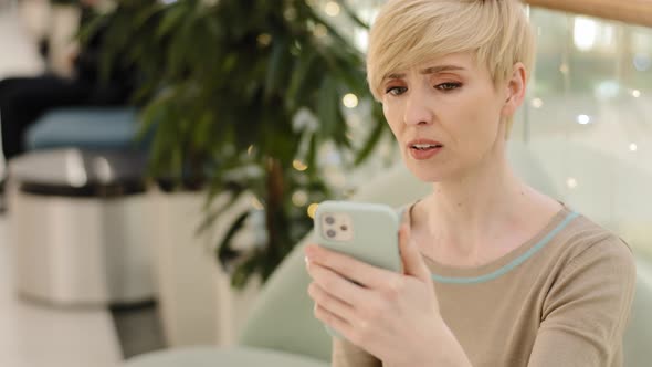 Stressed Nervous Adult Mature 40s Woman Looking at Cellphone Screen Feeling Frustrated Upset